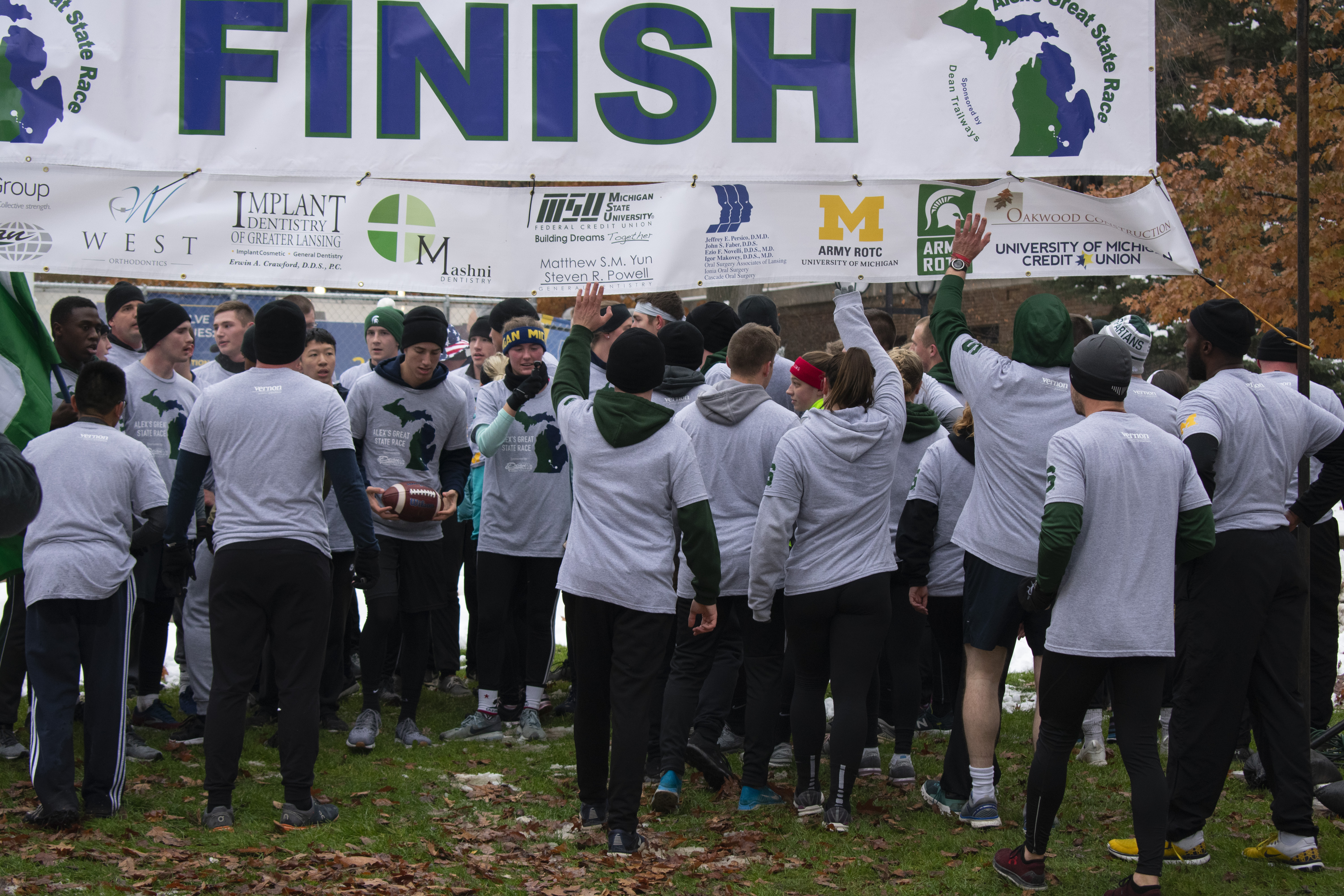 ROTC from U of M and MSU running under the finish line